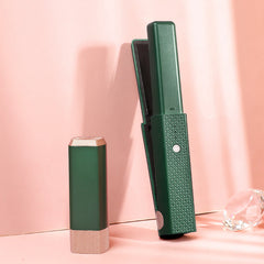 Green hair styling wand for women with textured grip and sleek design on pink background
