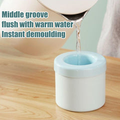 Portable silicone ice maker bucket being filled with warm water for easy ice demolding
